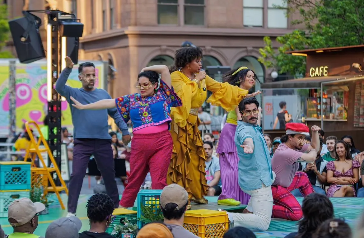 The Mobile Unit performing on a plaza stage with the audience on all sides